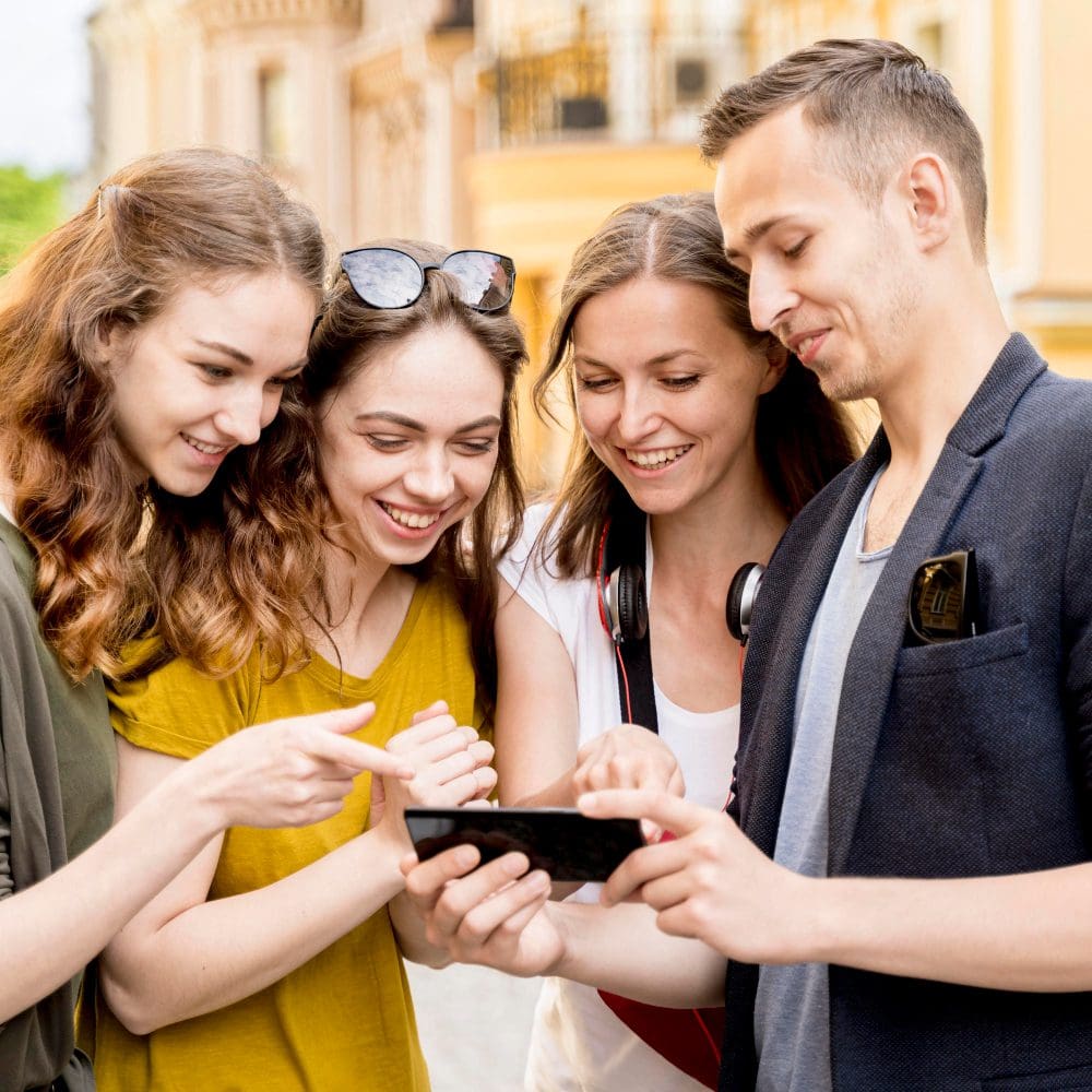 Digital marketing is essential for businesses to stary relevant. Group of friends, cell phone.