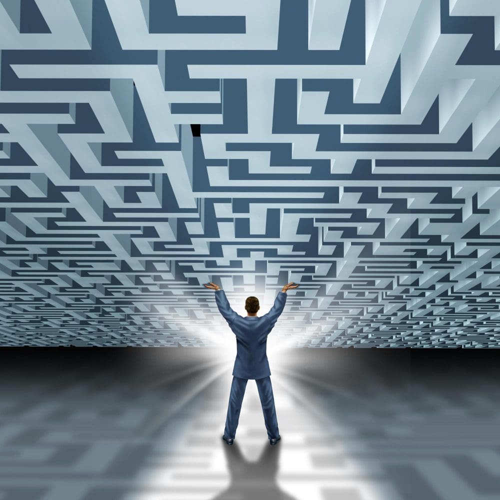 A businessman standing in front of a labyrinth, symbolizing the meaning and definition of local digital marketing. A businessman standing in front of a labyrinth, symbolizing the meaning and definition of local digital marketing.