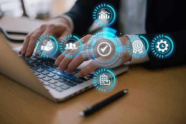 Digital marketing provides many ways to engage customers and drive conversions. A professional typing on a laptop.