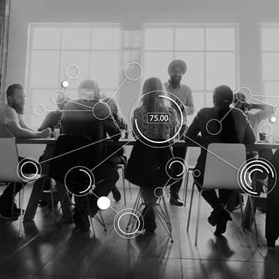 Having a solid online presence is a must for businesses to stay competitive. A group of people discussing digital marketing strategies around a table.