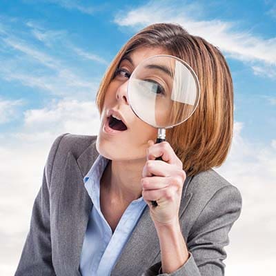 Crafting a comprehensive digital marketing plan is crucial for success in today's competitive online world. A business woman utilizing a magnifying glass to examine components of digital marketing.