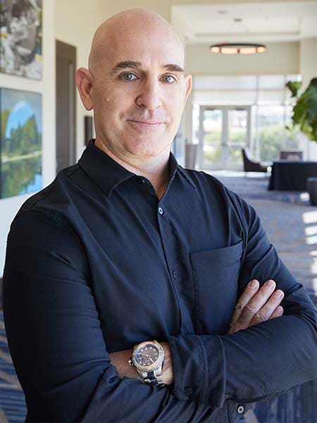 Brian Gibbs, a digital marketing consultant, wearing a black shirt standing in a lobby.